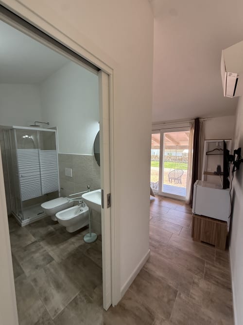 Modern bathroom with shower, toilet and bidet in Sardinia Holidays Navy Room, Torpè Italy with private veranda view