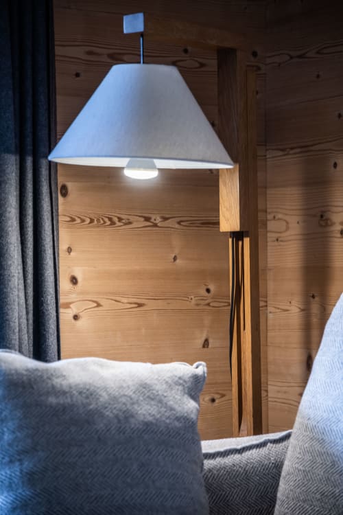 Modern pendant lamp with blue shade and wooden base in Le Tetralyre apartment at Le Chalet Mont-Blanc, Les Houches