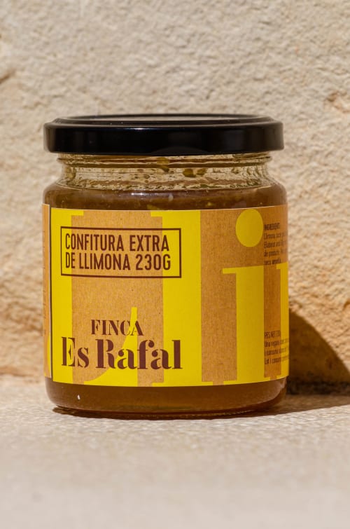 Finca Es Rafal lemon marmalade jar with yellow label against beige wall, Montuïri
