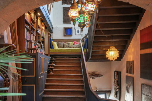 Alombre B&B staircase in Lectoure with ornate Turkish lanterns, bookshelf, and cozy reading nook