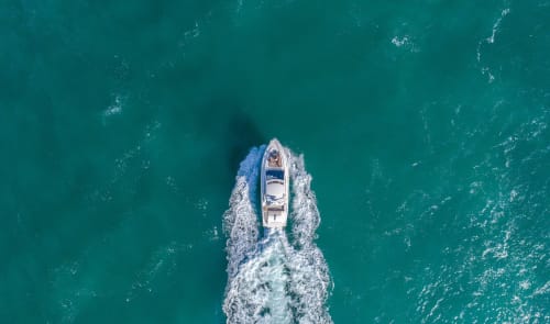Speedboat racing through turquoise waters near LH51 Rooms and Apartments, Italy