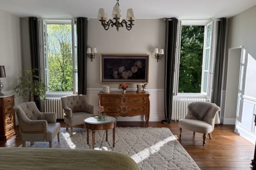 Elegant living area at La Maison 1680 with garden views, comfortable seating, fireplace, and period furniture in Couches,