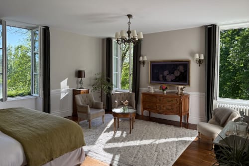 Elegant bedroom suite at La Maison 1680 with garden views, sitting area, flat-screen TV, and classic furnishings in Couches,