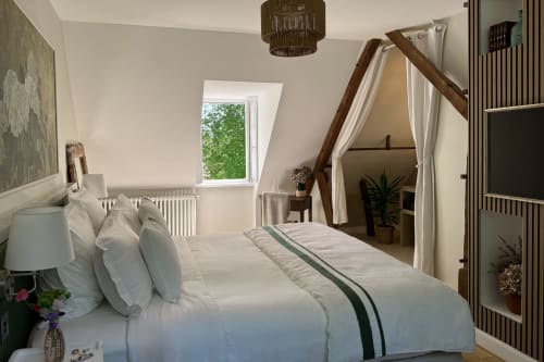 La chambre de Joseph at La Maison 1680 BnB in Couches features a luxurious bed with garden views and a canopy seating area.