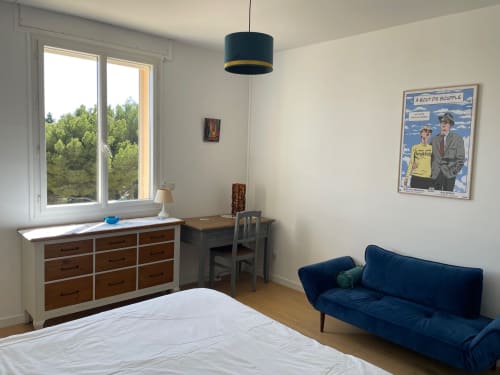 Bright apartment bedroom with blue sofa, desk, and sea view windows at Résidence Le Château Du Parc, Saint Raphaël