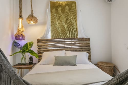 Oceanfront bedroom at Casa Amor in Isla Mujeres with wooden bed frame, white bedding, and coastal decor