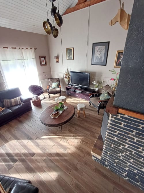 Spacious living room at Le gite des mousquetaires in Lanne en Baretous with wood flooring, fireplace, and panoramic views