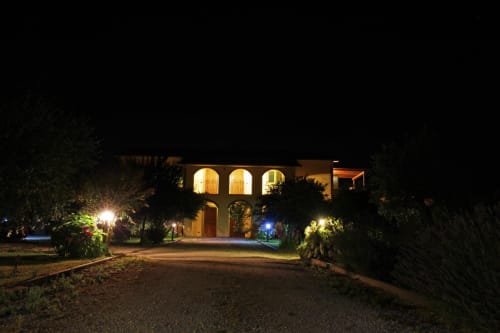Agriturismo Buriano in Lubriano lit up at night, showing the main building with arched windows and surrounding gardens