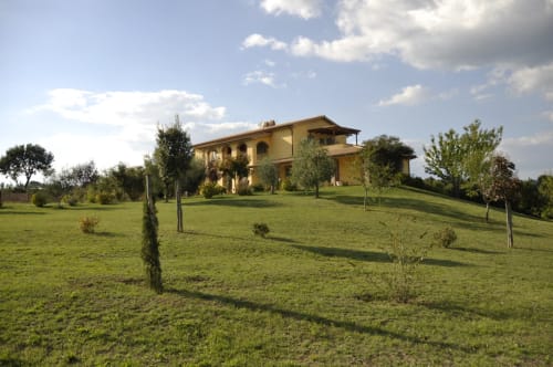 Agriturismo Buriano farmhouse in Lubriano, Italy with rolling green lawns and young vineyard plantings