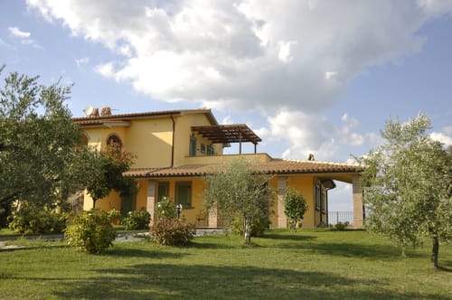 Agriturismo Buriano B&B in Lubriano, Italy - rustic yellow villa with terracotta roof surrounded by olive trees and gardens