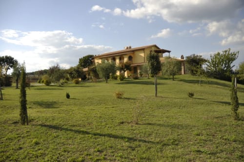 Agriturismo Buriano B&B in Lubriano, Italy surrounded by lush green grounds and cypress trees
