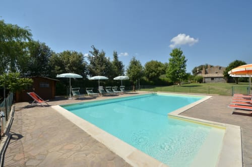 Agriturismo Buriano pool in Lubriano with loungers, umbrellas, and countryside views