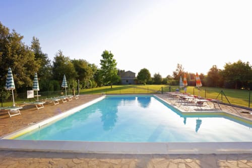 Resort swimming pool at Agriturismo Buriano in Lubriano with loungers and countryside views