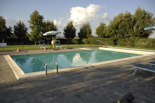 Swimming pool at Agriturismo Buriano in Lubriano, Italy with sun loungers and countryside views