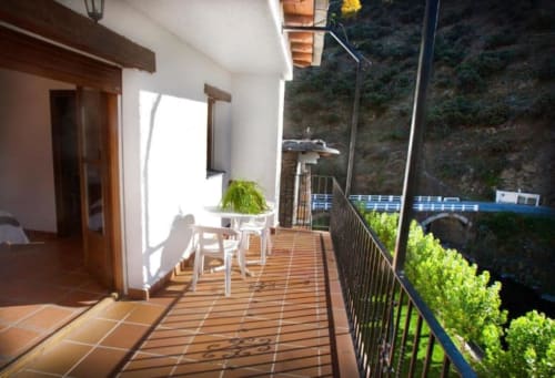 Hotel Mulhacén Trevélez terrace with wooden deck, seating, potted plant, mountain views
