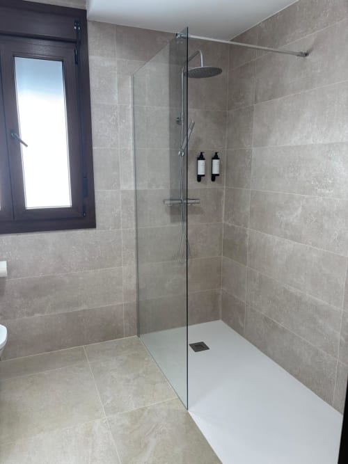 Modern glass shower enclosure with rainfall showerhead at Hotel Mulhacén Trevélez, Granada