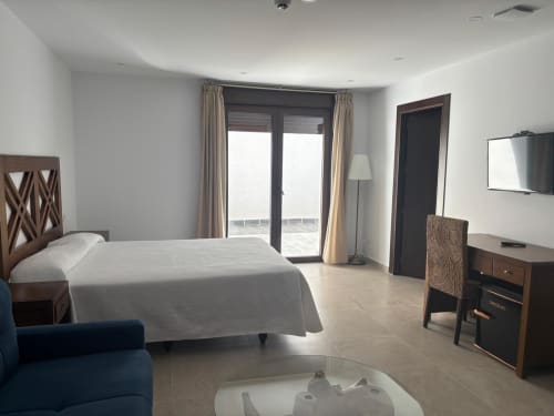 Junior Suite at Hotel Mulhacén Trevélez with river-view terrace, modern furnishings, and mountain views from Granada, Spain