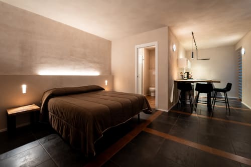 Camera moderna a Stone House Gebel el Son a Novi Velia con letto marrone, pavimenti scuri e zona lavoro