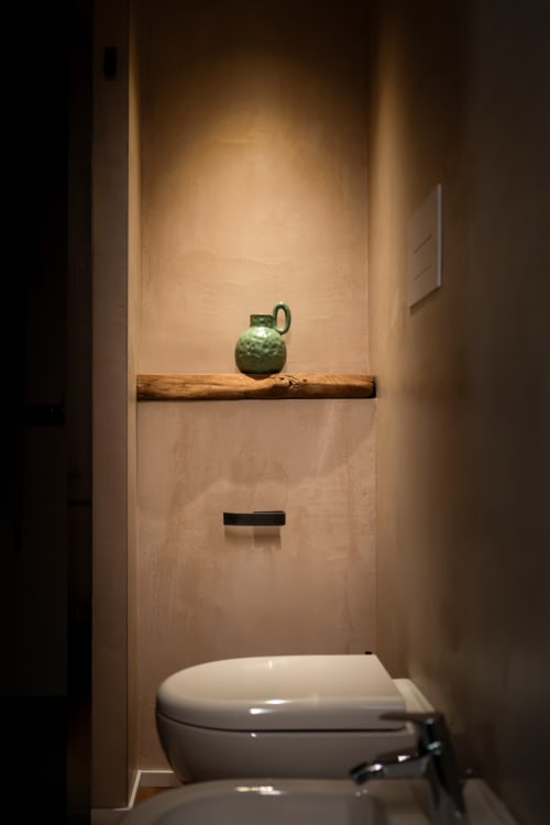 Bagno minimalista con wc bianco, ripiano in legno con brocca in ceramica verde, bagno in comune presso Stone House Gebel el