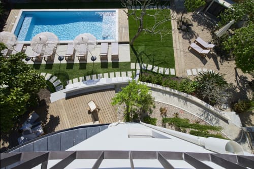 Aerial view of Casa Redonda Aroeira pool area with loungers, wooden decks, and lush gardens in Portugal