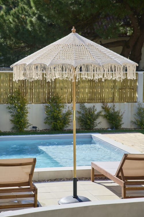 Cream macramé umbrella with fringe by Casa Redonda Aroeira villa pool, lounge chairs, Portugal