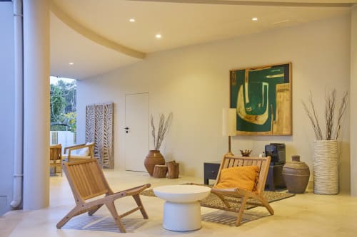 Modern villa living room at Casa Redonda Aroeira with wooden chairs, white decor, and contemporary art