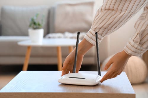 Guest adjusting WiFi router at El Chalecito de Alicante hotel in Alicante, Spain
