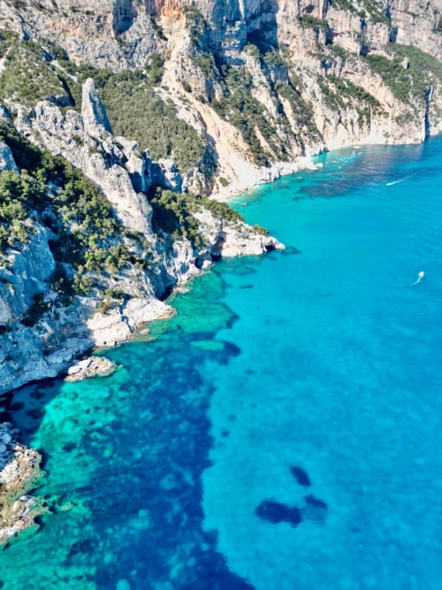 Turquoise Mediterranean waters meet white limestone cliffs near Muravera, Italy