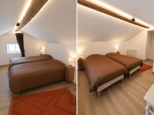 Cozy family room at Domaine de Beau Site with two brown beds, wooden beams, ambient lighting, and garden views in