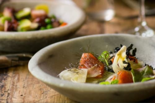 Gourmet plated dish at Haven Spa Luxury Loft in Como with salmon, fresh vegetables and microgreens
