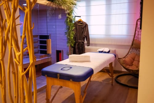 Luxury spa treatment room at Haven Spa Loft in Como with massage bed, hanging chair, and modern wellness amenities