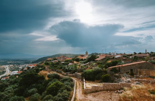 Hilltop village of Penamacor with terracotta roofs, stone buildings, and countryside views at Moinho do Maneio guesthouse