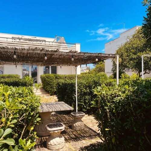 Terrazza panoramica di lusso a My Home Apulia a Veglie con pergolato, sedute e vegetazione rigogliosa