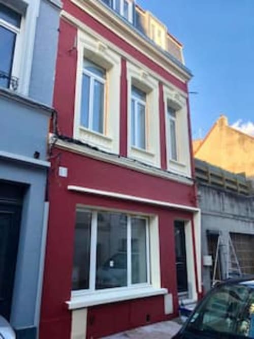 Façade de l'hôtel Les Logis d'Emma, style rouge et crème avec grandes fenêtres en centre-ville français