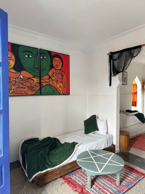 Namasté room at Yousurf Surfhouse hostel in Essaouira with colorful artwork, green bedding, and modern décor