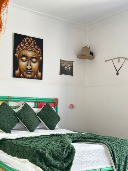 Namasté room at Yousurf Surfhouse in Essaouira with green bedding, Buddha wall art, and bohemian decor