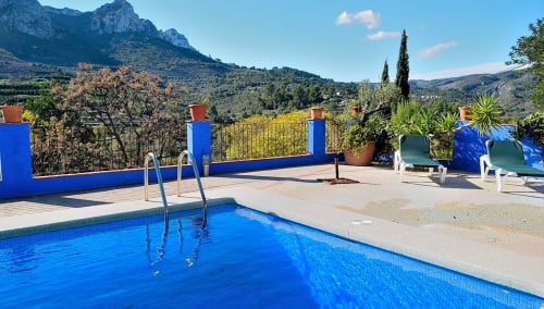 Casa Gallinera pool with mountain views, Benissivà Spain - blue swimming pool, loungers, and terrace overlooking hills