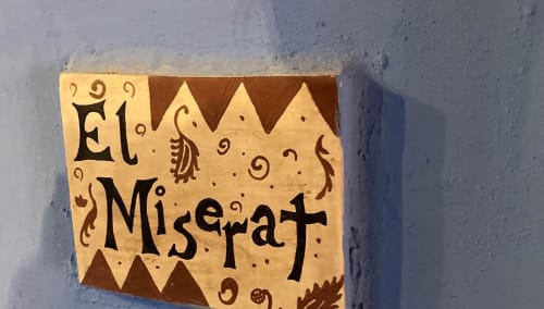 El Miserat room sign at Casa Gallinera in Benissivà with decorative wooden plaque and mountain view
