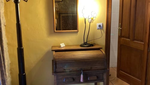 Wooden roll-top desk with decorative lamp in La Solana room at Casa Gallinera, Benissivà