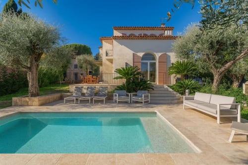Luxury villa with private pool, loungers, and Mediterranean landscaping in Cannes-Mougins