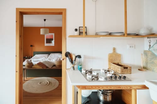 Modern kitchen and bedroom view in Gank Apartment at Kmetija Pečnik, Prevalje, with wooden furnishings and mountain views