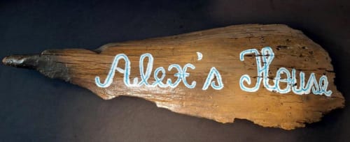 Señal de madera con letras blancas que dice "Aloe's House" en el hotel Smart Rent Fuerteventura