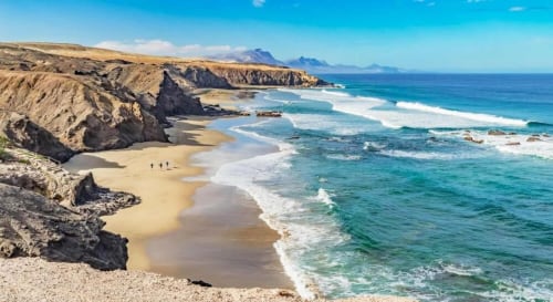 Costa de Fuerteventura espectacular con playa de arena dorada, aguas turquesas y acantilados volcánicos