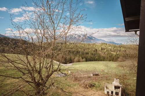 Scenic mountain view from Kmetija Pečnik Garden Suite in Prevalje with snow-capped peaks and green valleys