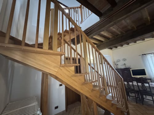 Wooden spiral staircase in Appartamento 6 at Agriturismo Aggazzotti, Colombaro, connecting to mezzanine level