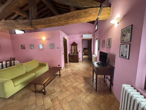 Pink living room with yellow sofa at Agriturismo Aggazzotti, Colombaro, Italy