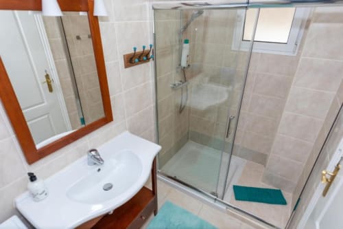 Baño moderno en apartamento Casa Laguna de Smart Rent Fuerteventura con lavamanos, espejo y cabina de ducha de cristal