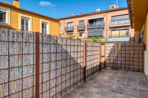 Gated terrace with wooden lattice fencing at Finques Garcia Enrich hotel in Palafrugell, Spain