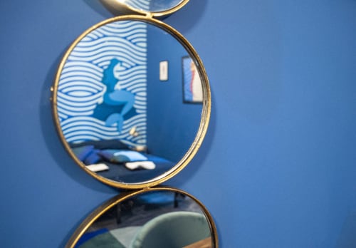 Gold-framed mirror on blue wall in Partenope's Room at LH51 Rooms in Naples, Italy