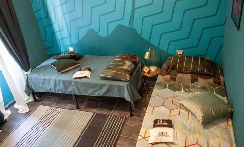 Modern twin bedroom at LH51 Vesuvio's Room in Naples with turquoise geometric wall and contemporary bedding